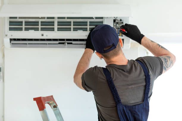 technician repairing air conditioner